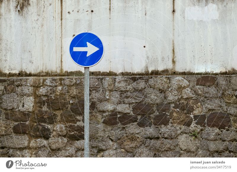 obligation traffic signal on the street in Bilbao city Spain arrow direction road asphalt warning road sign symbol way caution roadsign advice safety outdoors