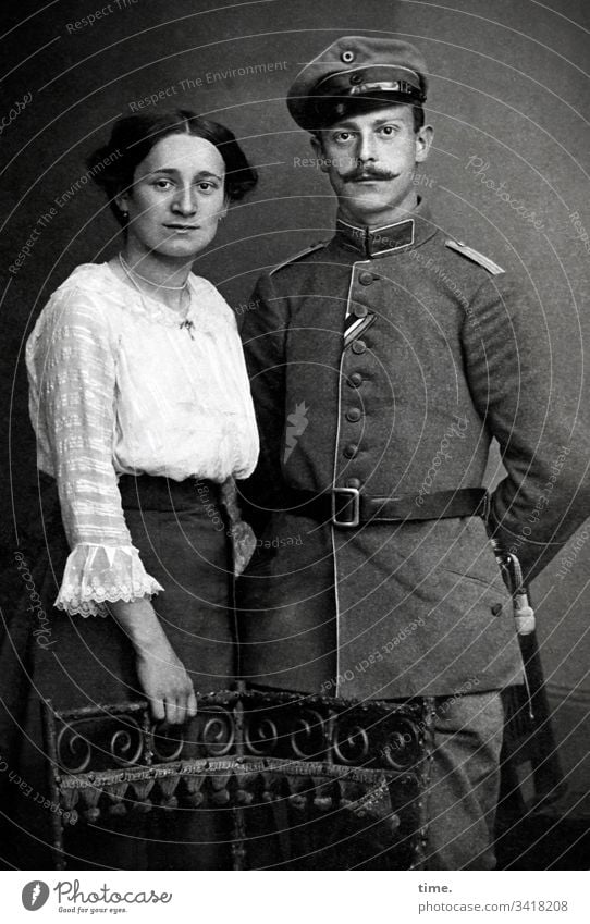 Appointment with the photographer Woman look Observe Dark-haired Curiosity observantly inquisitive B/W Man Artificial light Uniform Shirt Skirt insignia Stand