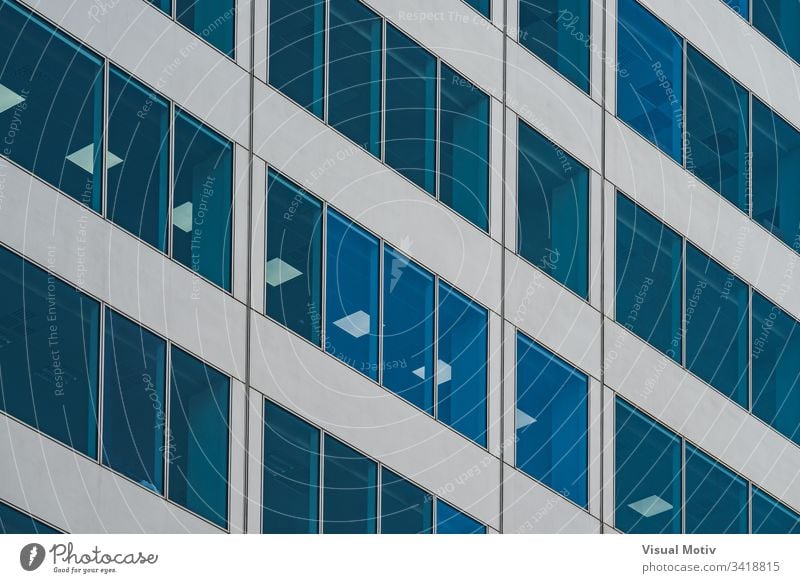 Symmetrical blue windows of an office building made of aluminum and glass facade architecture architectural architectonic urban color structure geometric