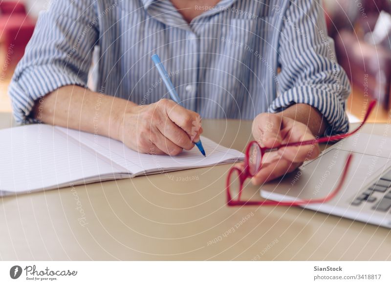 Middle age senior woman hands working on modern laptop at home electronics pc copy space watch blank screen concept using device empty above close-up keyboard