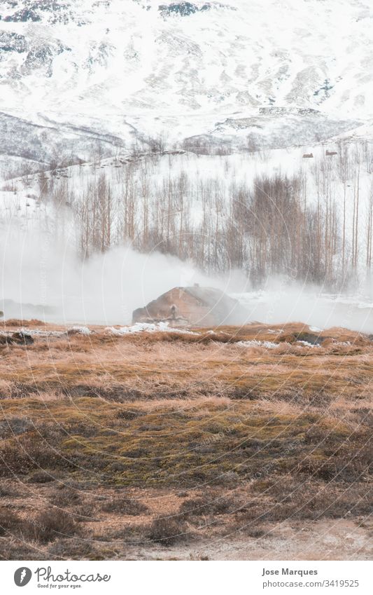 Landscape of a snowy mountain with fog and geyser landscape winter house home iceland cold background travel tourism traditional vikings nature