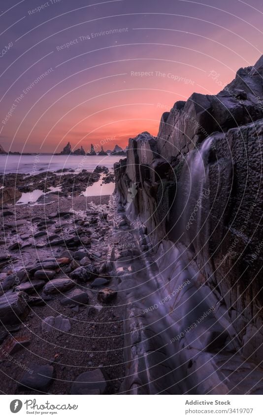 Lonely rocky seashore under evening sky nature stone water landscape sunset scenic coast travel beautiful tourism ocean adventure twilight amazing dusk wild