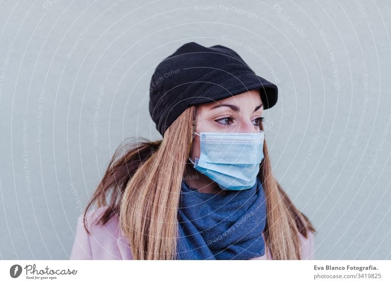 caucasian woman in the street wearing protective mask and using mobile phone. corona virus concept outdoors technology internet public adult infection space