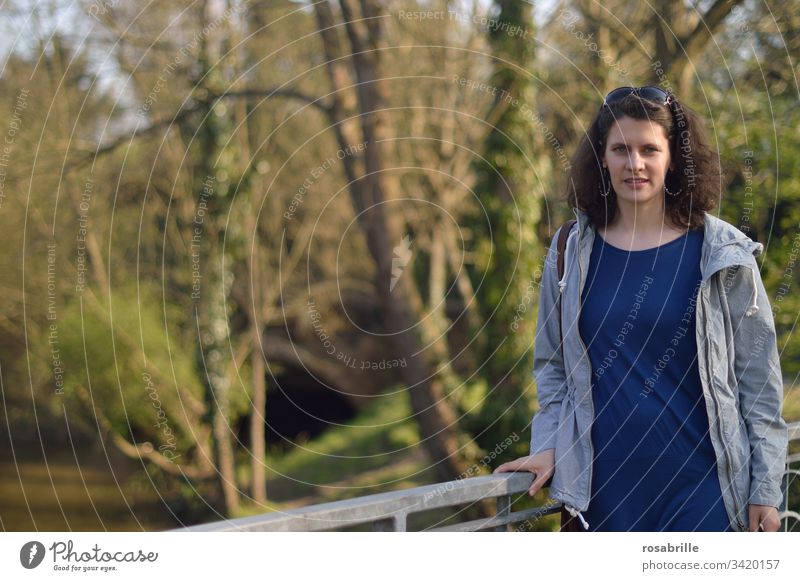 young brunette curly woman in the park Woman Young woman portrait long hair Feminine Adults free time naturally kind Pleasant Caucasian Appealing Congenial