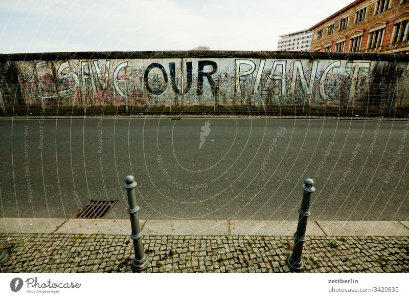 SAVE OUR PLANET on the outside Berlin The Wall graffiti Wall (barrier) Deserted Museum save our world writing Street tagg Copy Space topography of terror