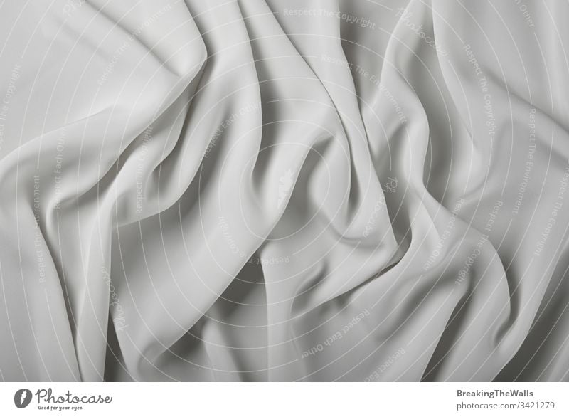 Background of white textile folded pleats Textile fabric background plait grey abstract tuck crease texture closeup cloth color industry elevated top view high