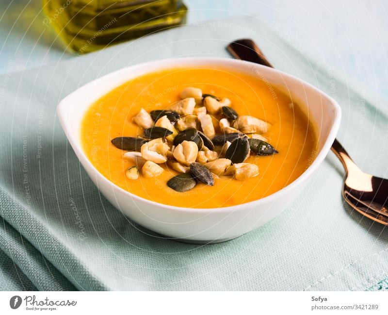 Bean squash creamy soup served with seeds and nuts pumpkin vegetable autumn bean bowl cannellini puree cashew chickpea cuisine delicious dinner carrot fall food