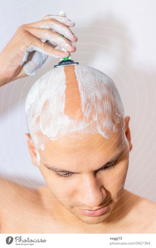 Man Shaving His Head Using White Foam appearance bald balding bath blade care concentration cropped depilation determination expressing eye face foam front guy