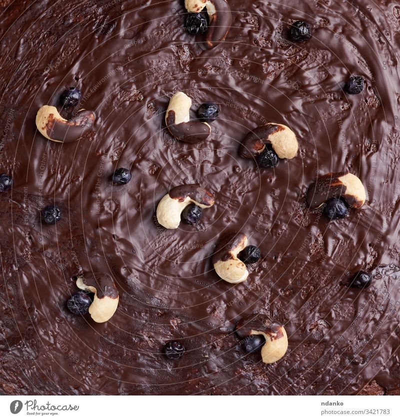 texture of baked brownie chocolate cake with chocolate poured. Cooked homemade food cashew cacao background bakery biscuit black closeup cocoa confectionery