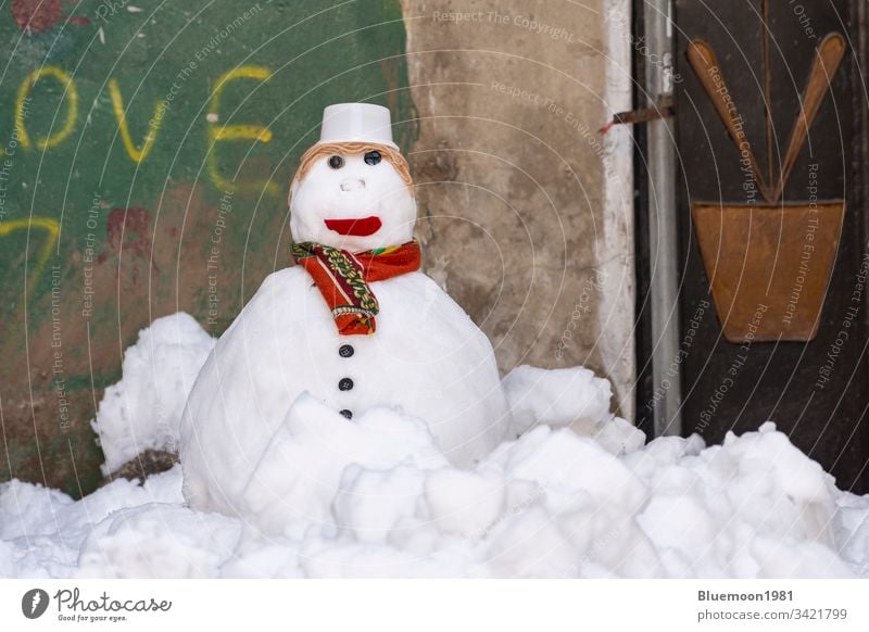 Snowman with scarf and hat stand alone at alley snowman face frozen ice winter leisure make snowman playful white wintertime cap cute home wall child season