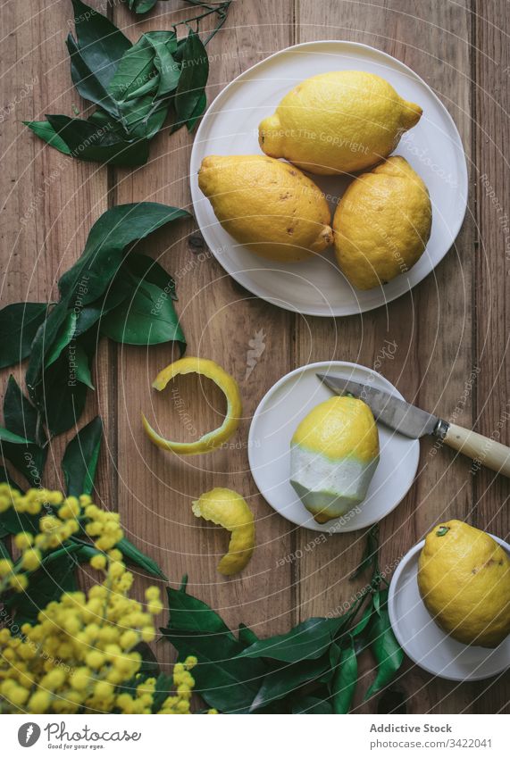 Composition of lemons and green leaves leaf peel fresh citrus food wooden organic healthy natural delicious table yellow raw juice sour rustic composition ripe