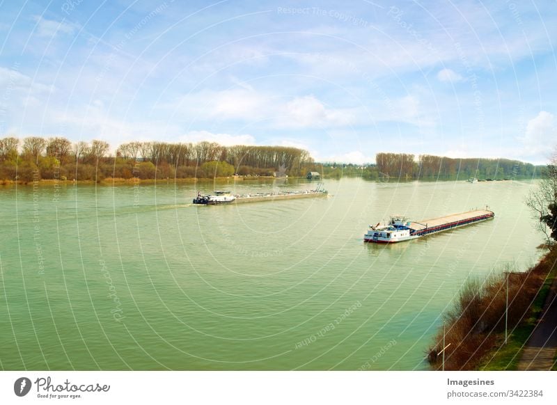 Container ships for export and import business and logistics. Aerial view of merchant ships crossing the Rhine in an area of Germany in Mainz. Water Transport International.