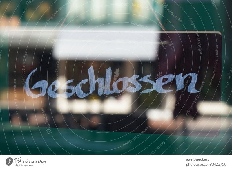 sign geschlossen meaning closed in german shop store shut germany business corona coronavirus lockdown economy bankruptcy window glass door entrance concept