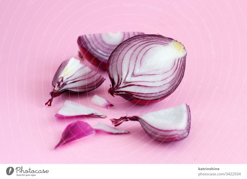 Purple onion on a light pink background purple red sliced half food healthy monochrome raw organic vegetable ingredient vegetarian ripe vitamin natural harvest