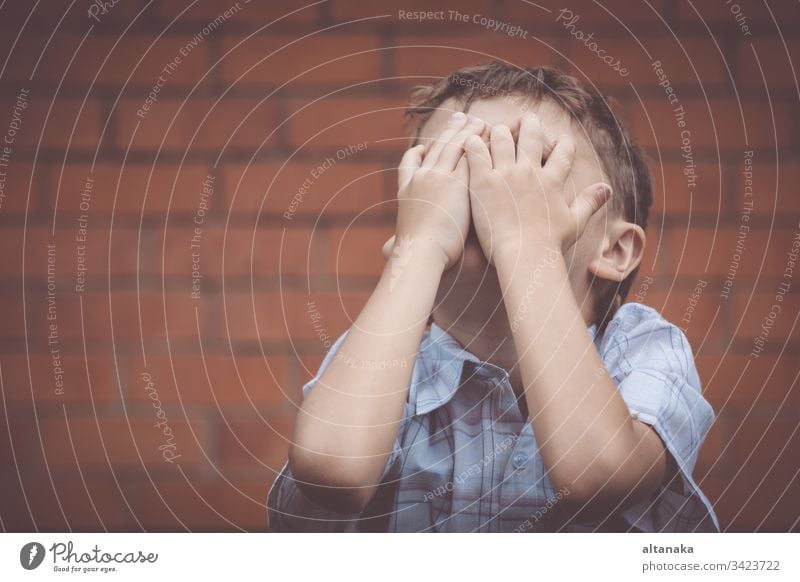 portrait one sad little boy standing near a wall innocence bad sorrow issues youth loss problem lost depressed serious lonely grief forgiveness anxiety unhappy