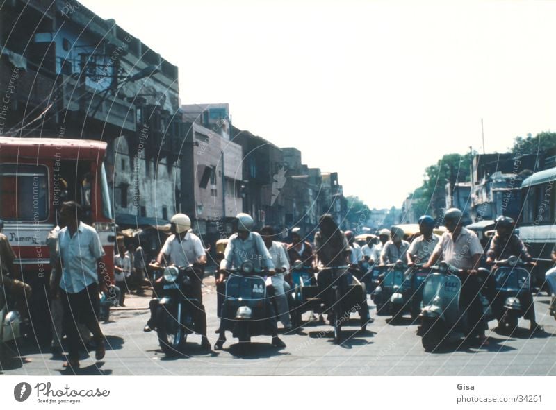 Street scene 2 Transport India Delhi Scooter Traffic regulation Helmet look to the right