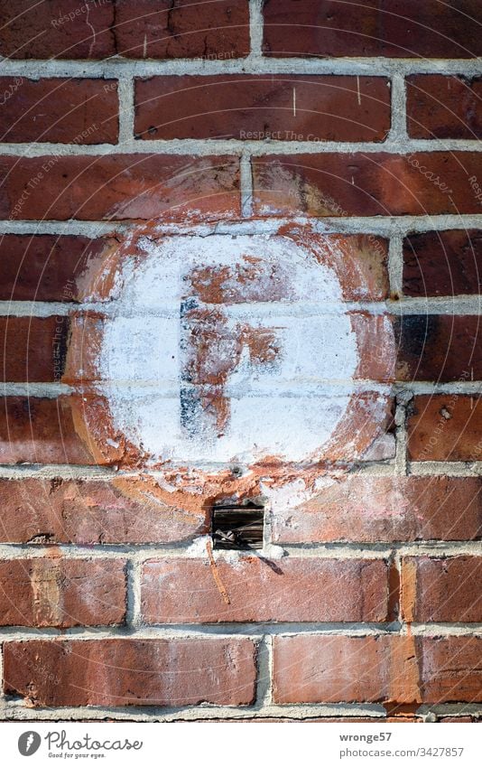 Large red F for indicating the fire extinguisher on a white background on a brick wall Letters (alphabet) Colour photo Day Characters Exterior shot