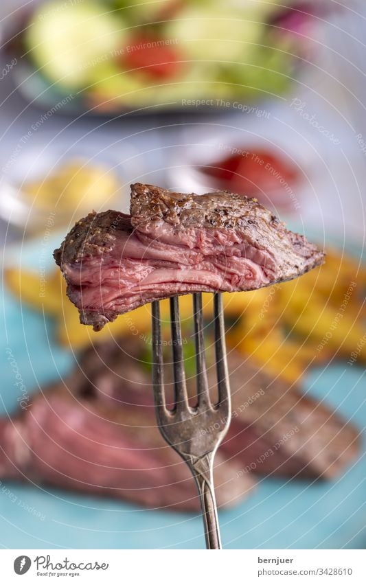 steak on a fork Steak Beef beef steak silver fork Slice Sirloin Frying roasted Meat Juicy slice Cut Fork Red Eating medium background Plate Dinner vintage