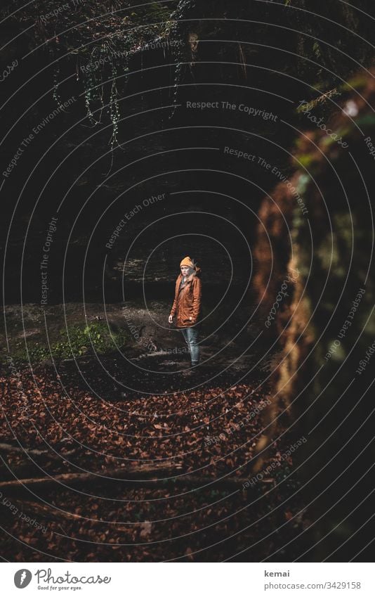 Woman in a ravine in the forest, looking into camera Mystic Nature Mysticism Mysterious Day Brown Natural Green Stone Canyon Human being foliage somber Dark