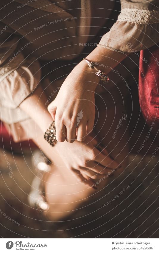 Elegant young woman's hands with painted nails and jewellery girl elegance elegant beauty fashion accessories beautiful soft red couch female portrait lady