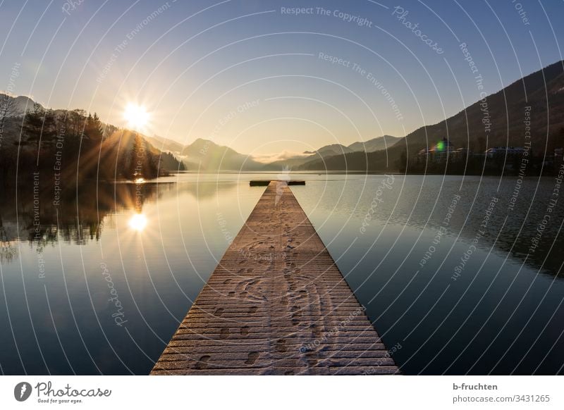 Small mountain lake with wooden jetty Lake Footbridge wooden walkway Austria Salzkammergut Morning Moody sunbathe Sunrise reflection tranquillity Calm mountains