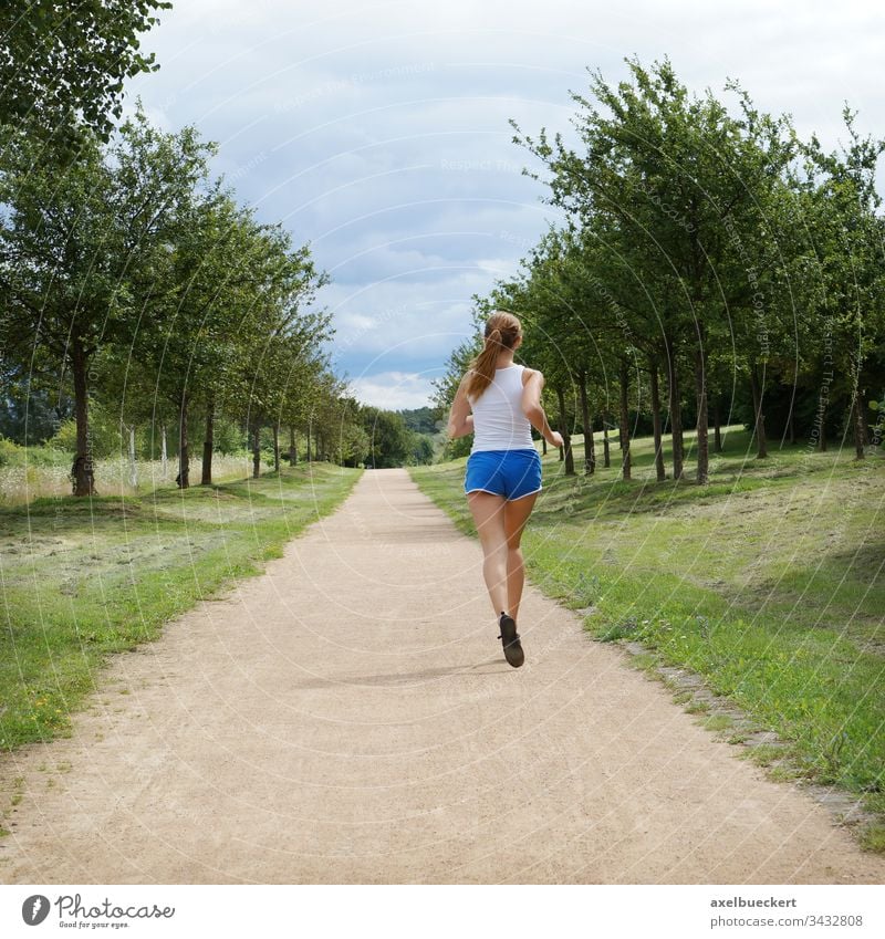 young woman jogging alone Jogging Running Woman Girl Jogger Sports Nature Sportswear Fitness Healthy Park youthful person Caucasian Lifestyle Outdoors