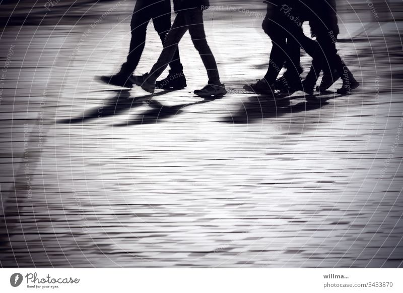 group of people walking across a public square persons Group city stroll Shopping trip To go for a walk Human being Shadow Youth (Young adults) Commute Street