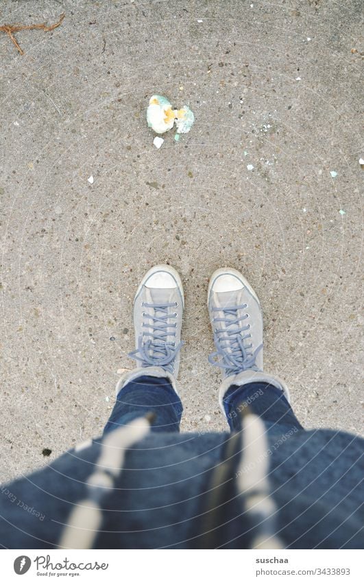 Easter is cancelled Woman Human being Stand Street Cold Winter Asphalt Spring Exterior shot Feasts & Celebrations Egg boiled egg Easter egg Broken dropped Food