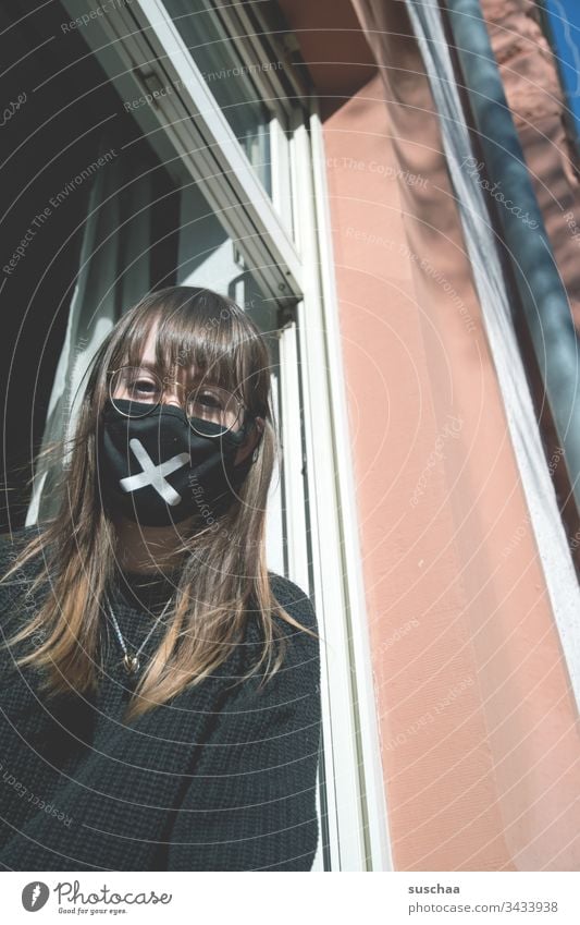 teenager with face mask at the window | corona thoughts Youth (Young adults) Young woman at home home office Eyeglasses stay at home Crisis corona crisis