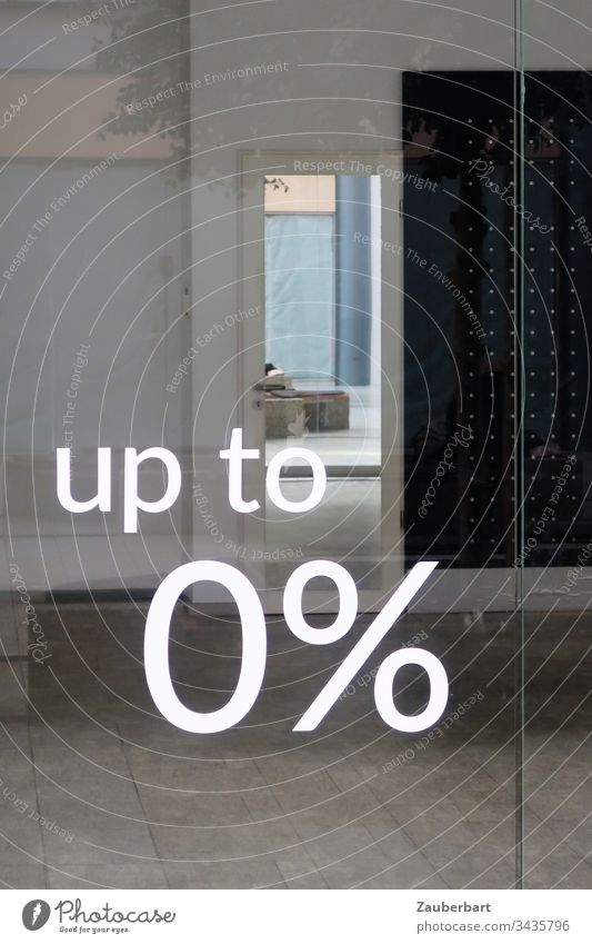 View into an empty shop through a glass pane with lettering 0% Load Empty nil Percent crash Crisis Economic crisis Gray Window tiles writing Characters Discount