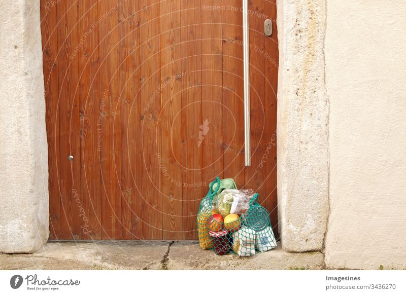 Delivery purchase during quarantine. Shopping bag with groceries, food at the front door, neighbourhood support - concept for quarantine period due to coronavirus infection Covid-19