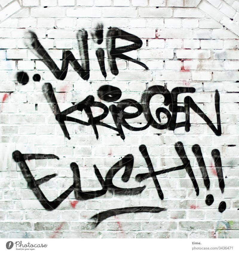 It smells like... Trouble Wall (building) Wall (barrier) Brick White threat Letters (alphabet) graffiti Exclamation mark imperative Warn Catch get Aggravation