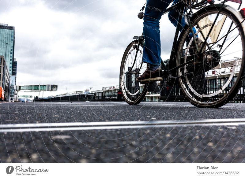 Cyclists at a shipping terminal with overcast sky Wheel cyclists Bicycle Cycling Movement Speed Adults Transport wharf Landing quay Shipping terminal moor