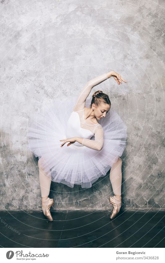 Elegant ballerina in white dress dancing against rustic wall action adult attractive background balance ballet body choreography classic classical dance dancer