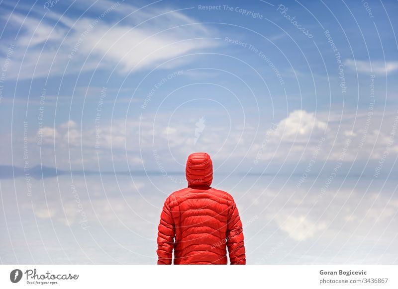 Man standing at Salar de uyuni salt flat in Bolivia man altiplano altitude america andes area blue bolivia bright calm color day desert destination dry