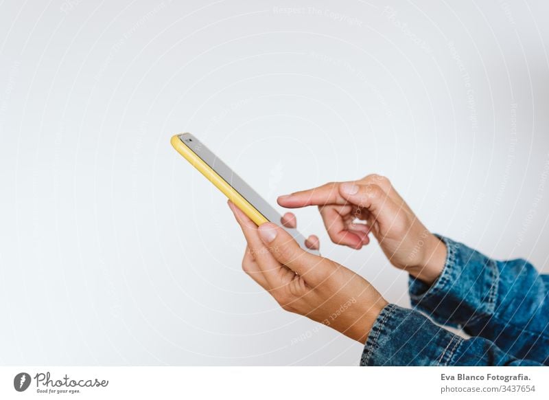 close up view of a woman using mobile phone indoors. Technology concept girls female one person unrecognizable technology wireless working internet texting