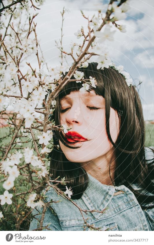 Beautiful young woman posing near spring flowers portrait beauty pretty face model art artistic mood moody beautiful natural real natural looking sun sunny