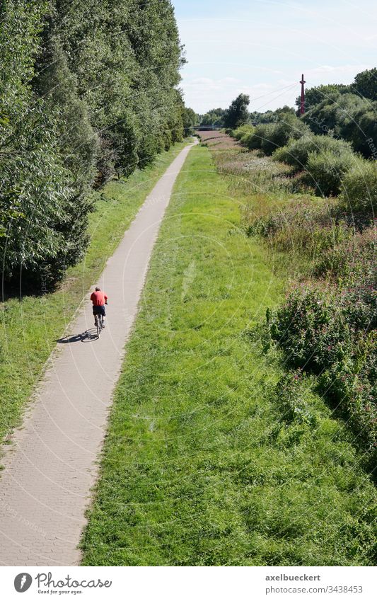 cyclist cycling on bicycle path in nature bike unrecognizable person green landscape leisure recreation sport ride riding biking bicycling activity outdoor