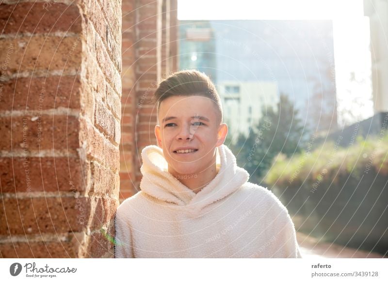 Portrait of young male with hands on pocket leaning on wall outside outdoors man portrait grey smiling happy 20s horizontal adult confident copy space content