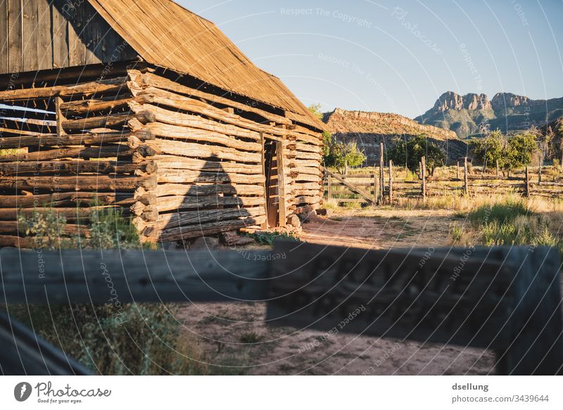 Private property on which a cabin made of wooden beams stands in the evening light Signs and labeling Hut Wood Wooden hut Wooden house Barn Deserted Arise Trip