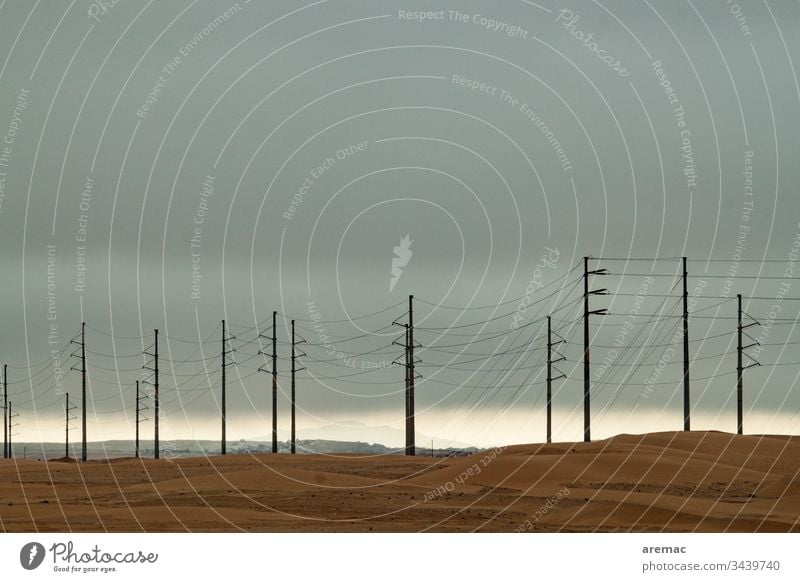 Power poles in the desert Electricity pylon Cables stream Sand Desert Weather gtau Namibia Light Sky Africa Colour photo Exterior shot Deserted