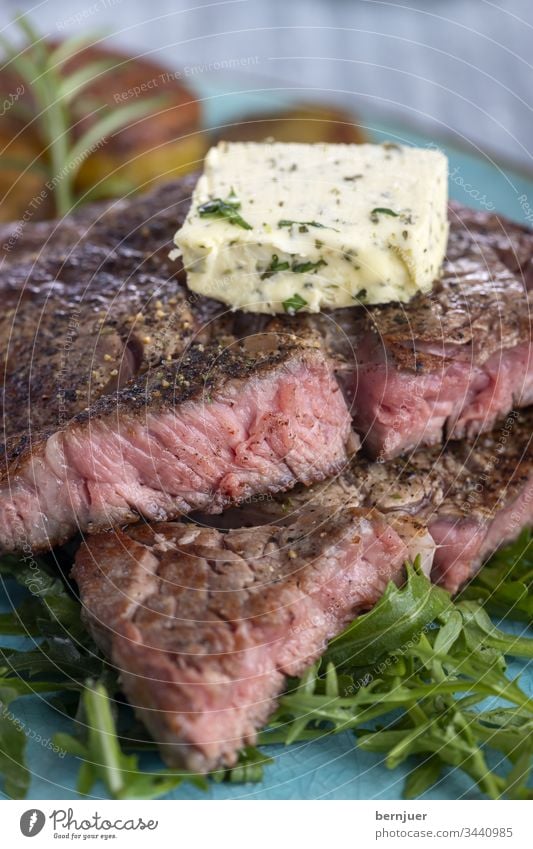 juicy grilled steak on the plate Steak Juicy Garlic Herb-flavoured butter herbaceous Butter potato Mushroom Rosemary Restaurant Argentinean porterhouse steak