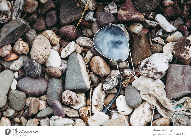 Broken sunglasses on the stone bank with reflection of the sky spieglung Sunglasses Sky Blue Close-up Gray Smashed window shattered broken Pattern Exterior shot