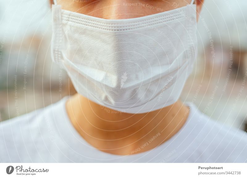 Closed face of a young woman where she is seen wearing a mask to avoid any contagion. Protection concept in times of pandemic pollution asian sick coronavirus