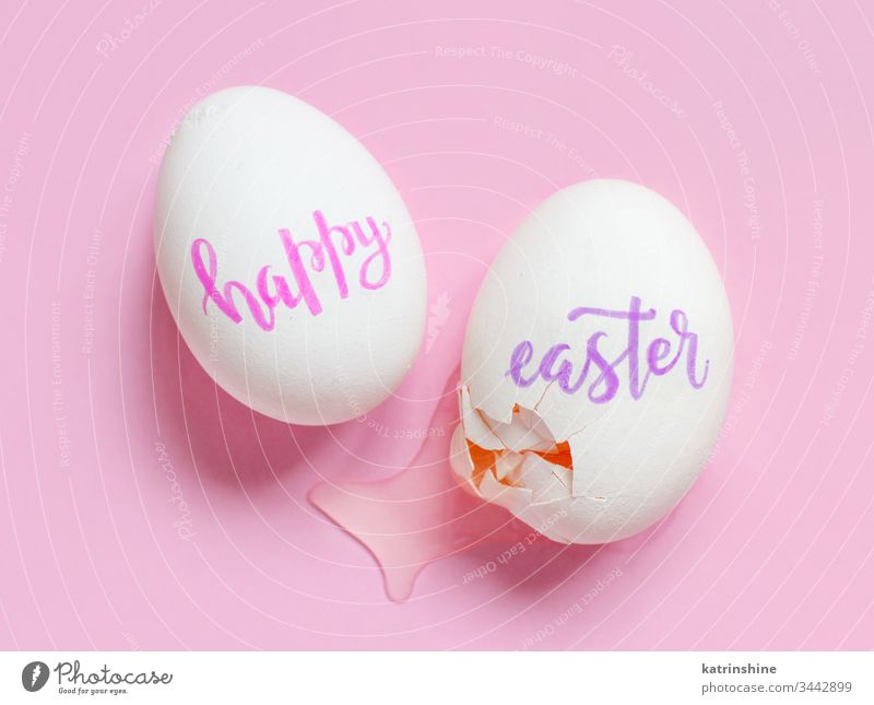 Broken eggs with handwritten inscription HAPPY EASTER over pink background happy happy easter broken broken egg top view concept covid-19 copy space