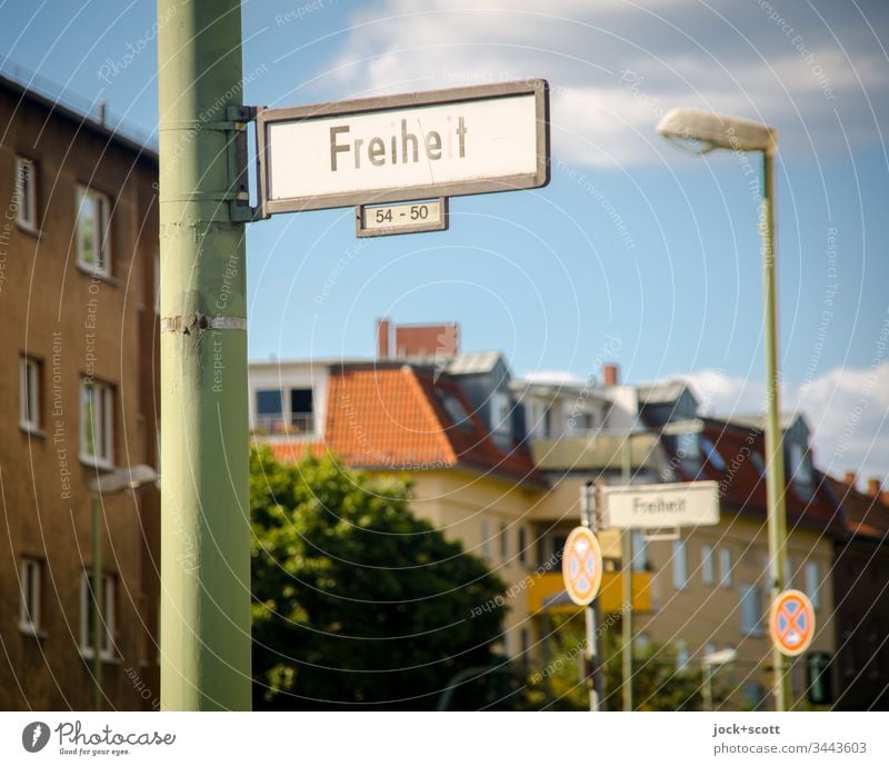 Freedom lies in the middle of the city, unfortunately with no stopping street sign Housefront No standing House numbers Traffic infrastructure Road sign