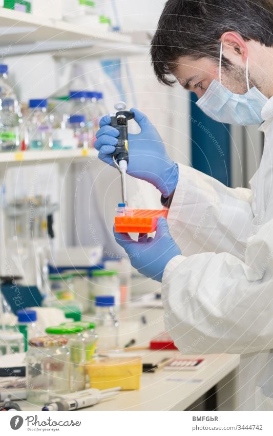 man pipetting in the laboratory dropper pipette analysis analyzing biological biotechnology care chemical chemist chemistry clinic corona coronavirus