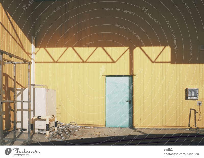 back door Home improvement store Wall (building) Metal Tin sheet metal Yellow Roof Shadow Sunlight Contrast Door worn-out Exterior shot Colour photo Deserted