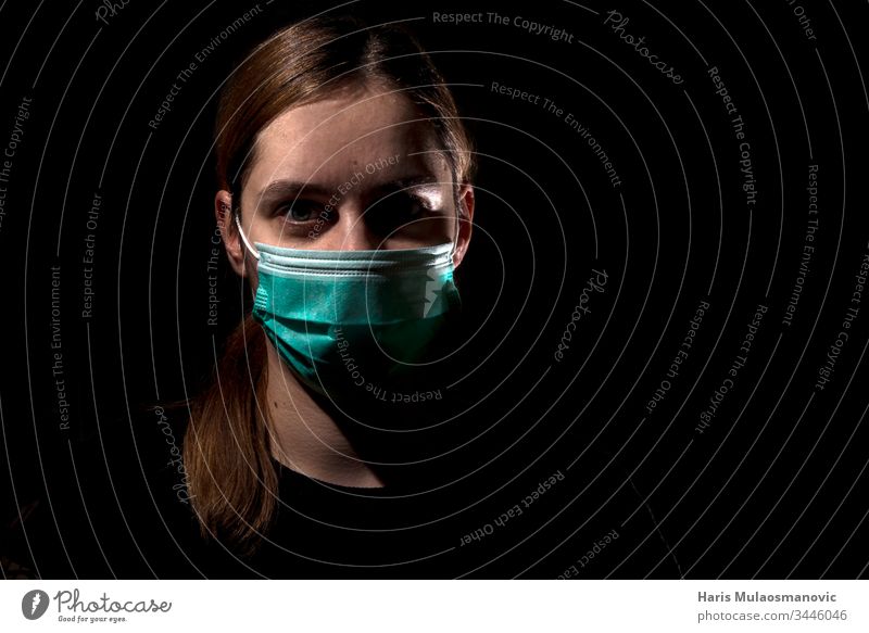 Woman with medical mask for protection of corona virus covid-19 SARS-CoV-2, woman with mask on black background 30s adult apocalyptic caucasian color