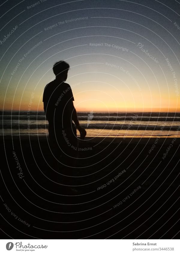 Silhoutte of a man on the beach at sunset Beach Sunset Silhouette Light Sunlight Ocean Beautiful Surfer Aquatics Cool holiday feeling vacation travel Horizon